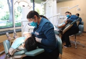 Two kids playing a video game in the dental office