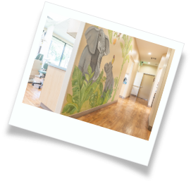 Two kids playing a video game in their pediatric dental office